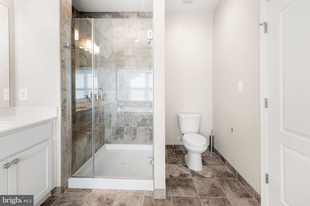 bathroom with vanity, toilet, and walk in shower