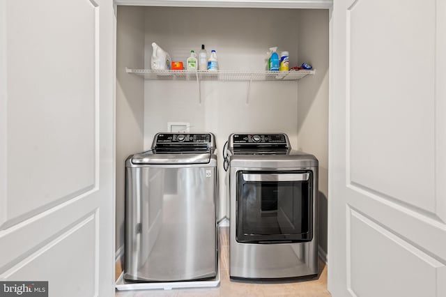 washroom with tile patterned flooring and separate washer and dryer