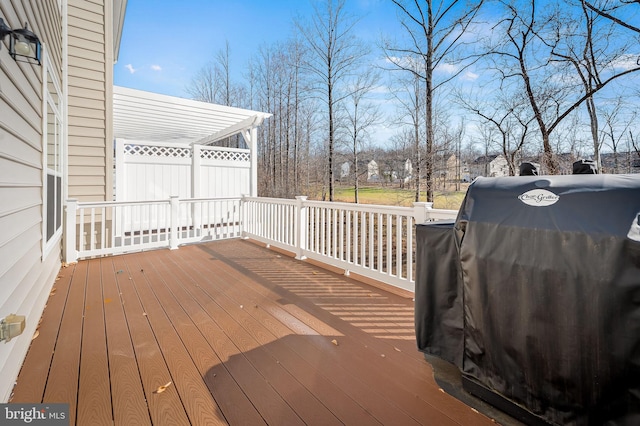 wooden deck with a grill