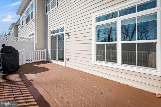 wooden terrace with a grill