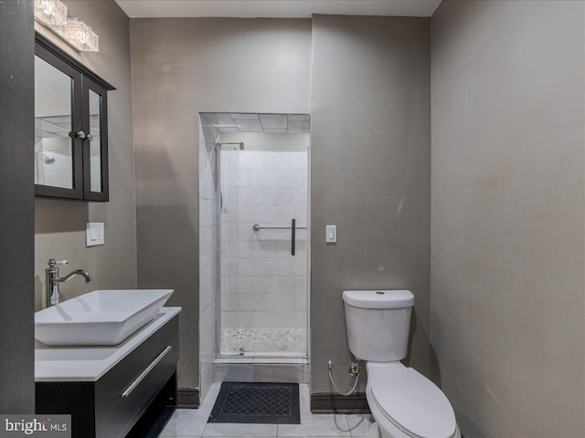 bathroom with vanity, tile patterned floors, a shower with door, and toilet