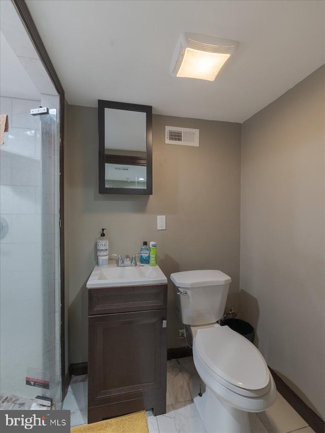 bathroom with vanity, walk in shower, and toilet