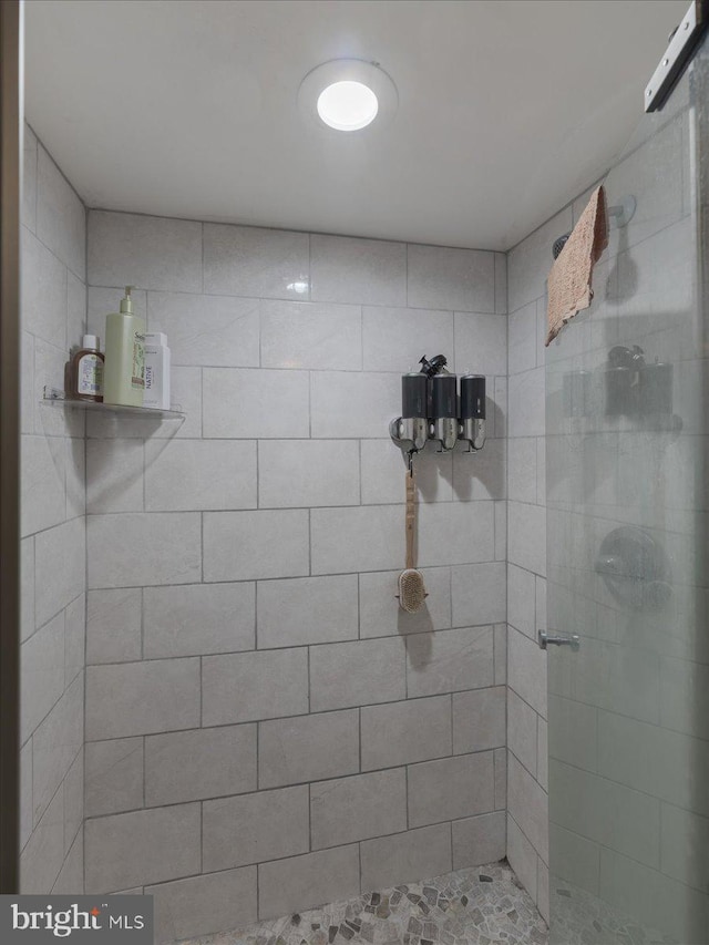 bathroom featuring a shower with door