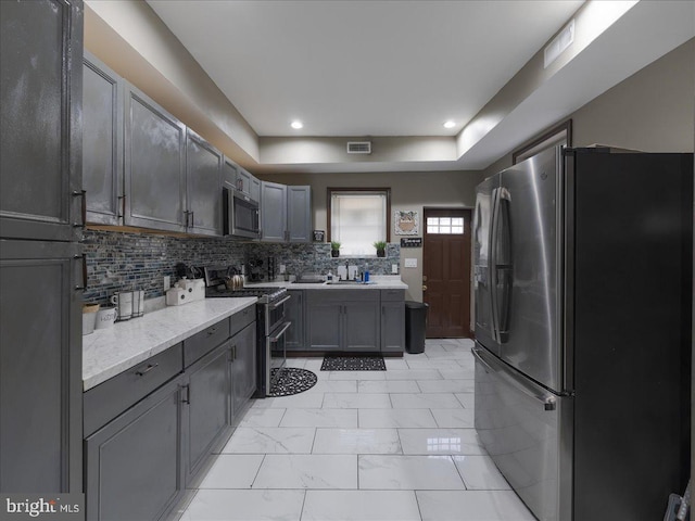 kitchen featuring appliances with stainless steel finishes and decorative backsplash