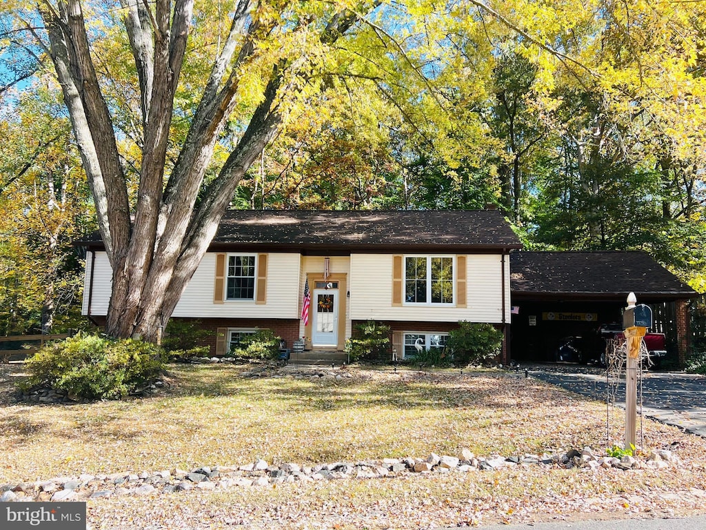 bi-level home featuring a carport