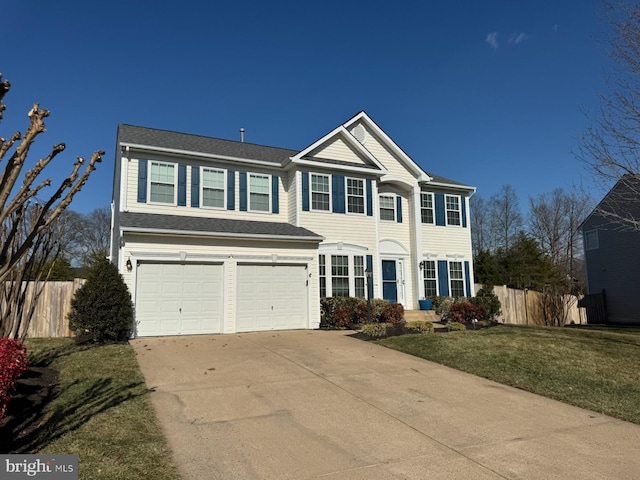 view of front of house with a garage and a front lawn