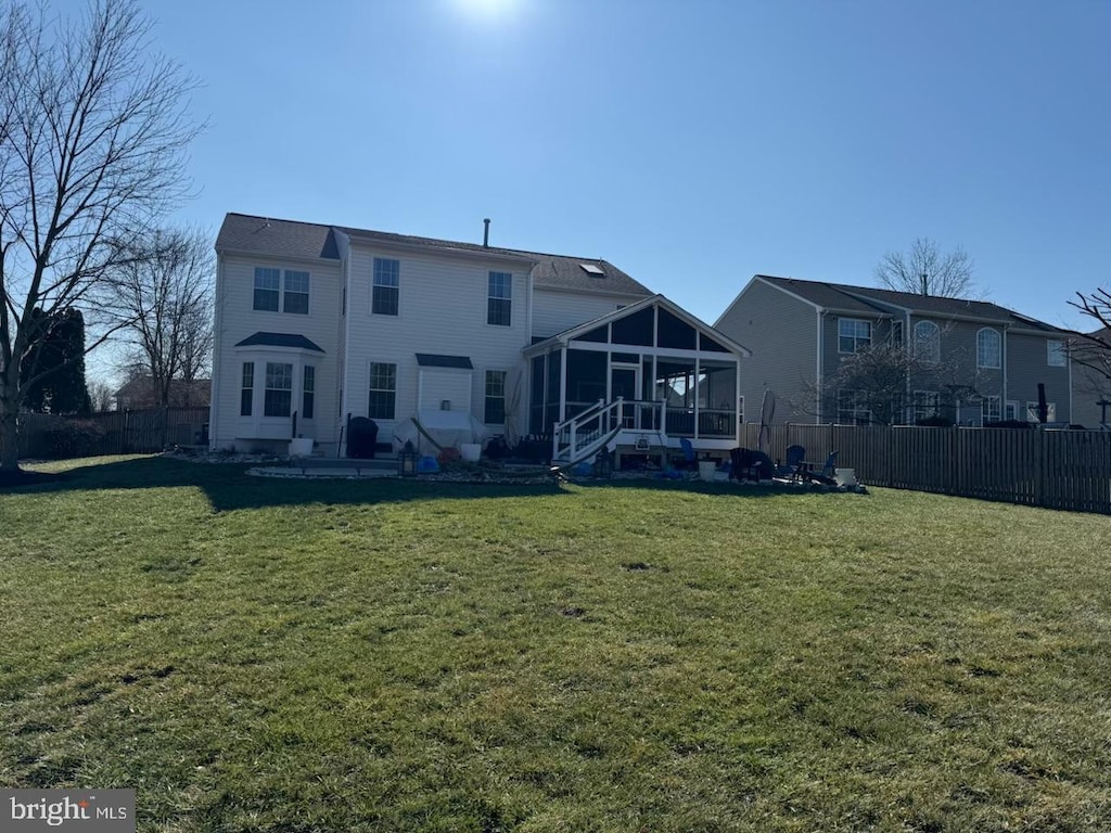 back of house with a patio, a sunroom, and a yard