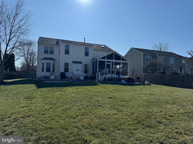 back of house with a patio, a sunroom, and a yard