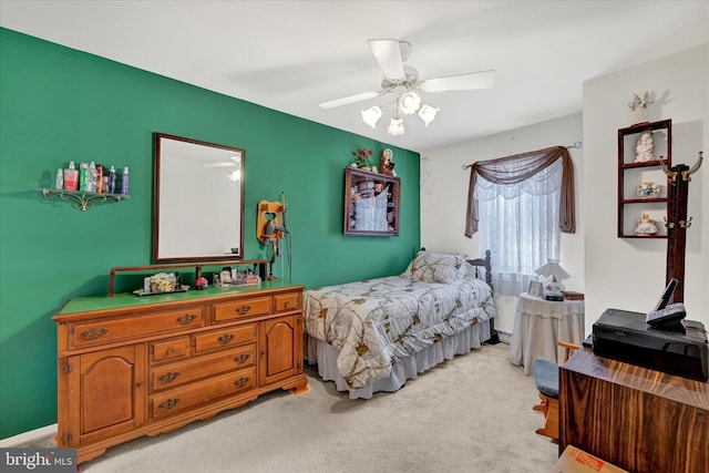 bedroom featuring light colored carpet and ceiling fan