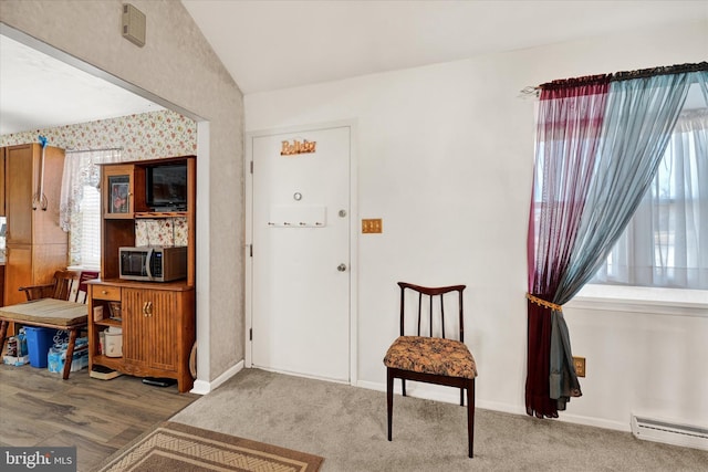 entryway with carpet floors and baseboard heating