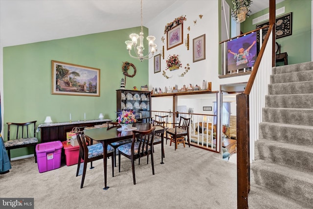 dining area with light colored carpet, high vaulted ceiling, and a notable chandelier