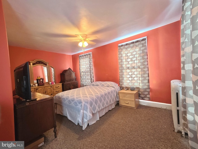 carpeted bedroom featuring ceiling fan and radiator heating unit