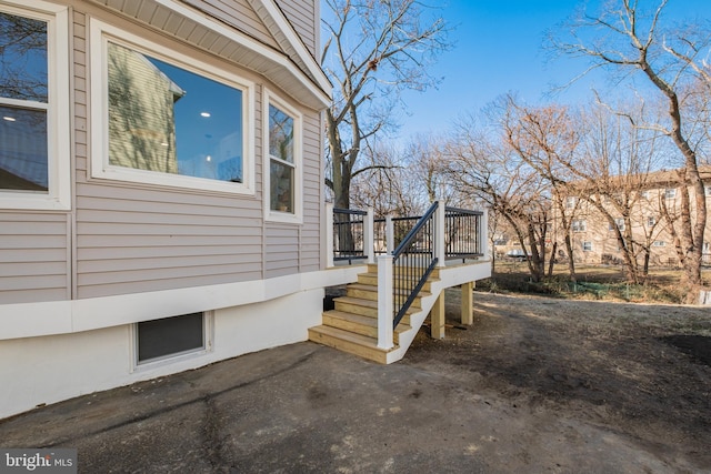 view of property exterior featuring a wooden deck