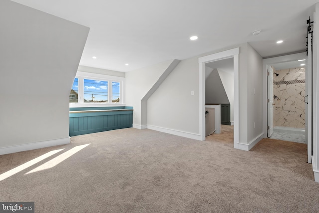 additional living space featuring light colored carpet