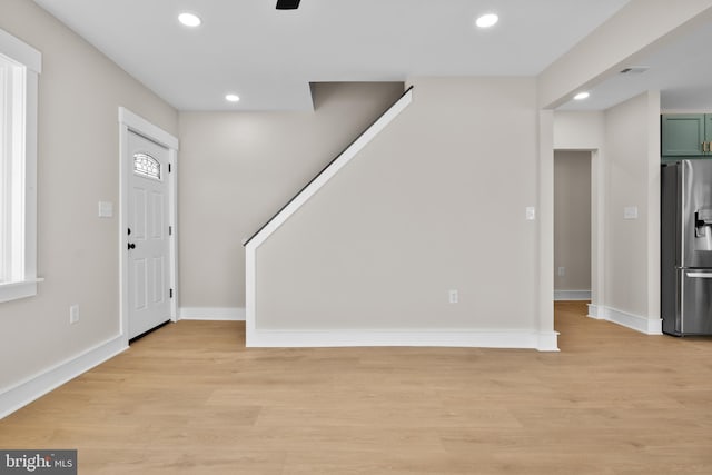 entrance foyer with ceiling fan and light hardwood / wood-style flooring