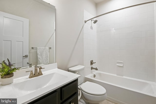 bathroom with washtub / shower combination, vanity, and toilet