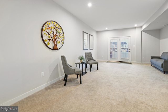 sitting room with light carpet, baseboards, and recessed lighting