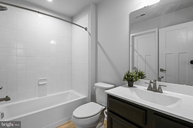 bathroom featuring visible vents, vanity, toilet, and tub / shower combination