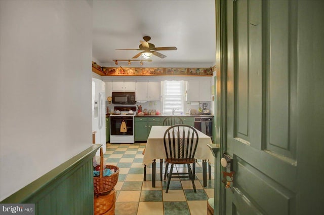 kitchen with sink, white appliances, green cabinetry, ceiling fan, and white cabinets