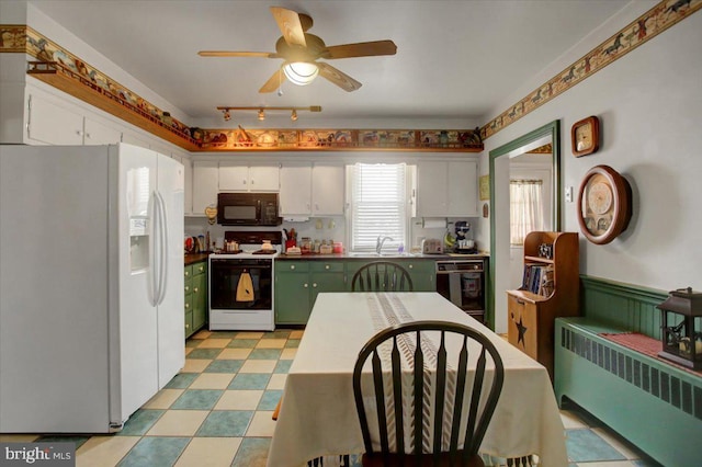 kitchen featuring dishwasher, stove, white cabinetry, radiator heating unit, and white fridge with ice dispenser