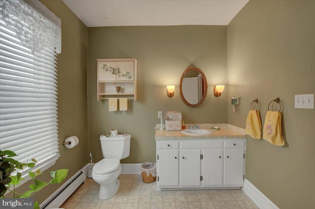 bathroom featuring vanity, baseboard heating, and toilet