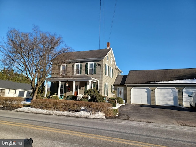 colonial home featuring a garage and covered porch