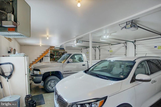 garage with white refrigerator and a garage door opener