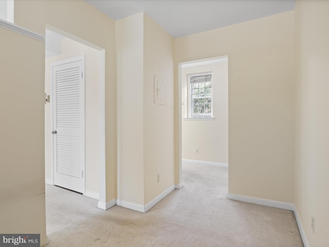 hallway featuring light colored carpet