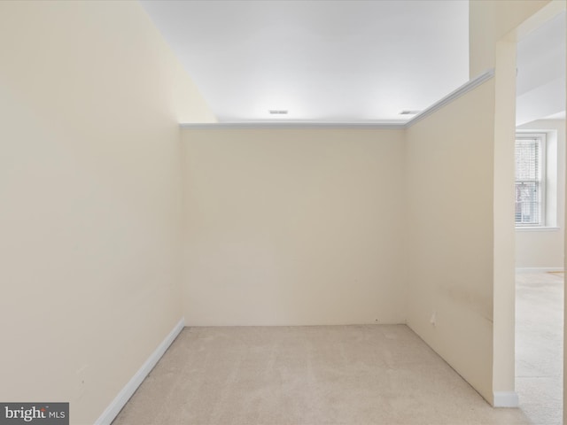 unfurnished room featuring light carpet