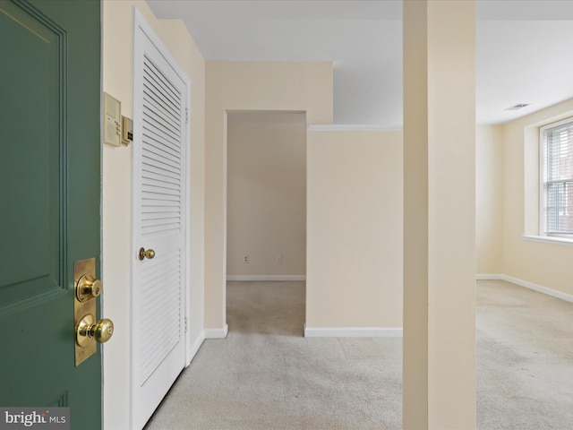 hallway with light colored carpet