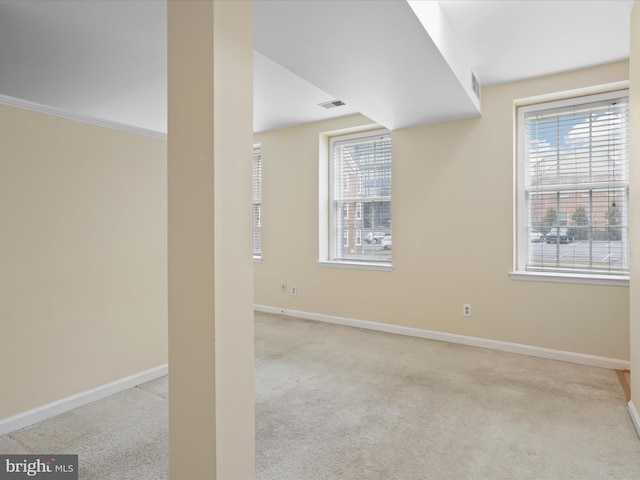 basement with light colored carpet and a wealth of natural light