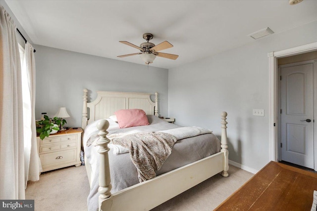 bedroom featuring light colored carpet and ceiling fan