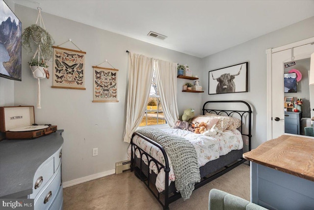 carpeted bedroom featuring baseboard heating