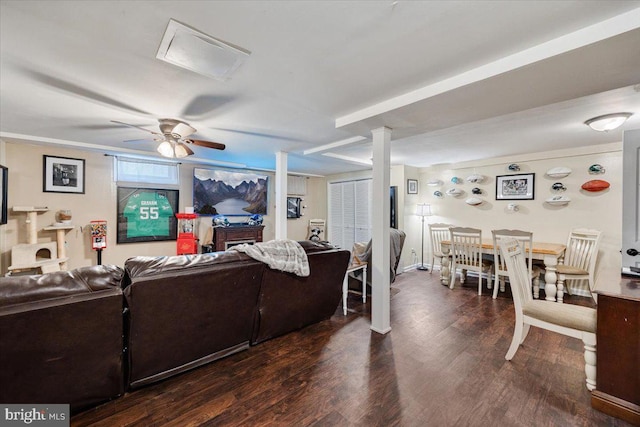 living room featuring ceiling fan and dark hardwood / wood-style flooring