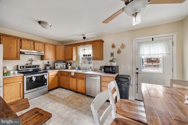 kitchen with stainless steel appliances, sink, pendant lighting, and ceiling fan