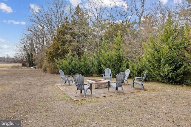 view of yard featuring a patio and a fire pit