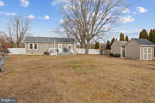 back of house featuring a storage unit and a lawn