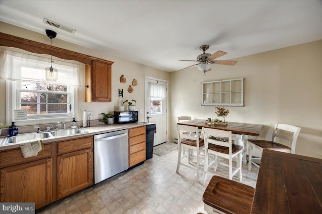 kitchen featuring pendant lighting, sink, dishwasher, and ceiling fan