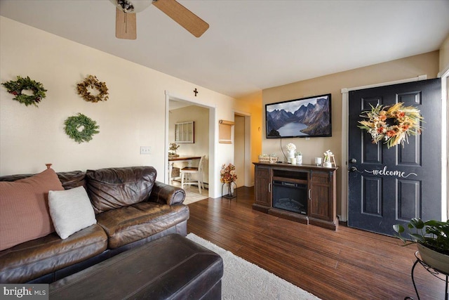 living room with dark hardwood / wood-style floors and ceiling fan