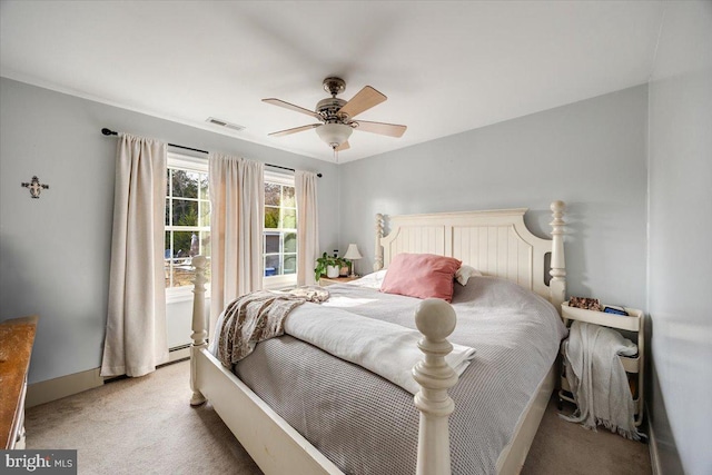 bedroom with carpet, ceiling fan, and baseboard heating