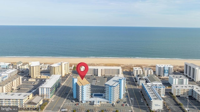 drone / aerial view featuring a water view and a beach view