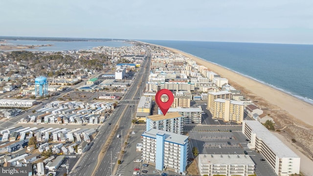 drone / aerial view featuring a water view and a beach view