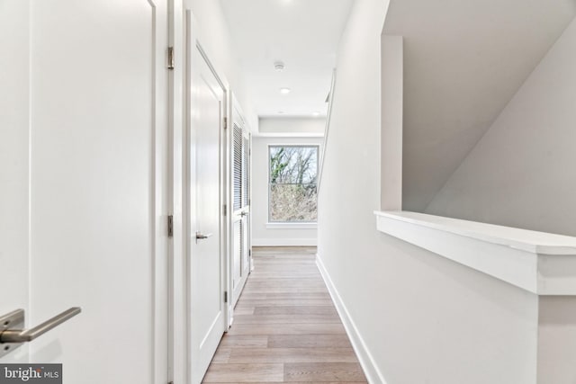 hall with light hardwood / wood-style flooring