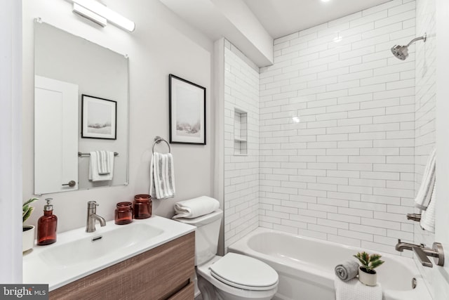 full bathroom with tiled shower / bath, vanity, and toilet