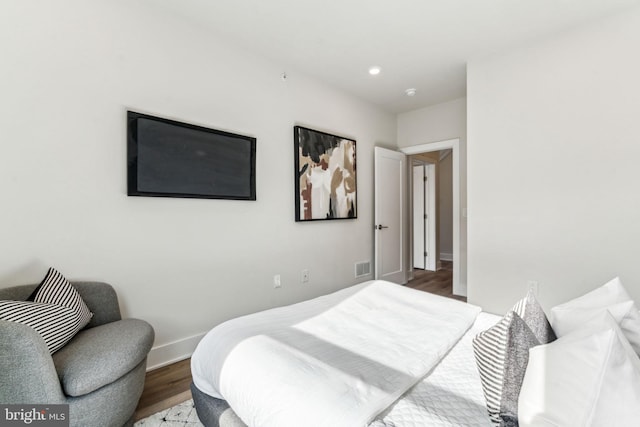 bedroom with hardwood / wood-style floors