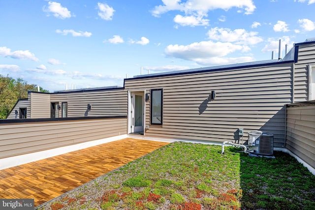 exterior space featuring a lawn and central air condition unit