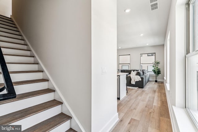 stairs with hardwood / wood-style floors