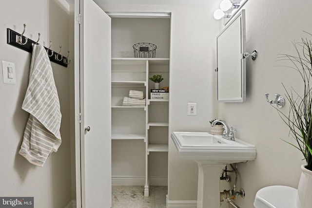 half bath with marble finish floor and toilet
