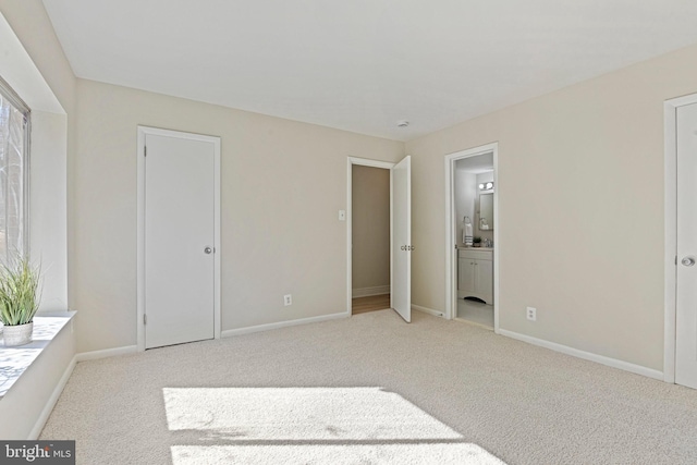 bedroom with carpet, baseboards, and connected bathroom