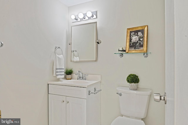 half bathroom featuring toilet and vanity
